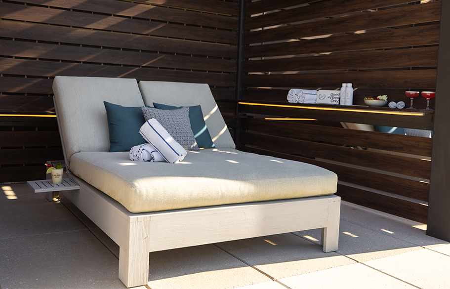 a lounge chair with pillows on it