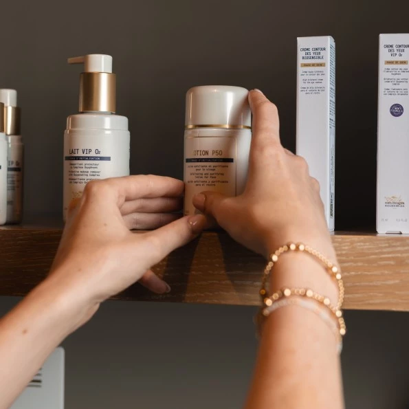 a person's hands touching a bottle of cream preview