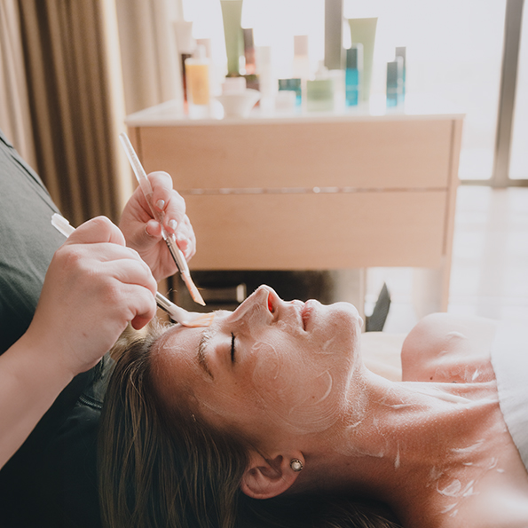 a woman lying down with a brush on her face preview