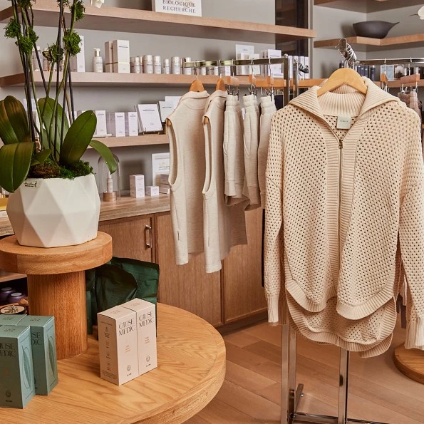 a clothing store with a plant in a pot