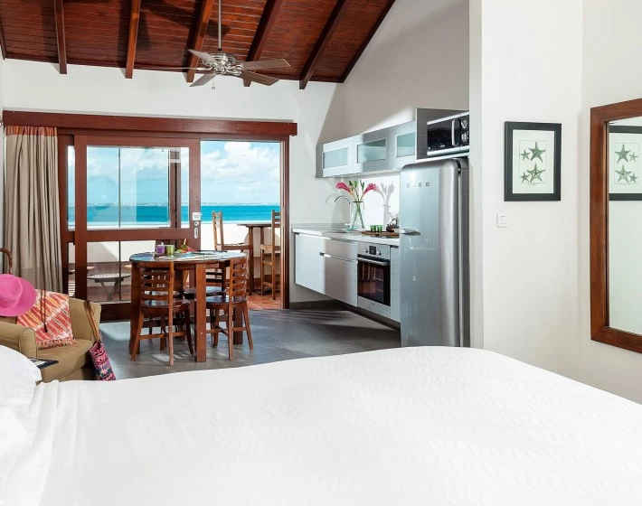 a bedroom with a table and chairs