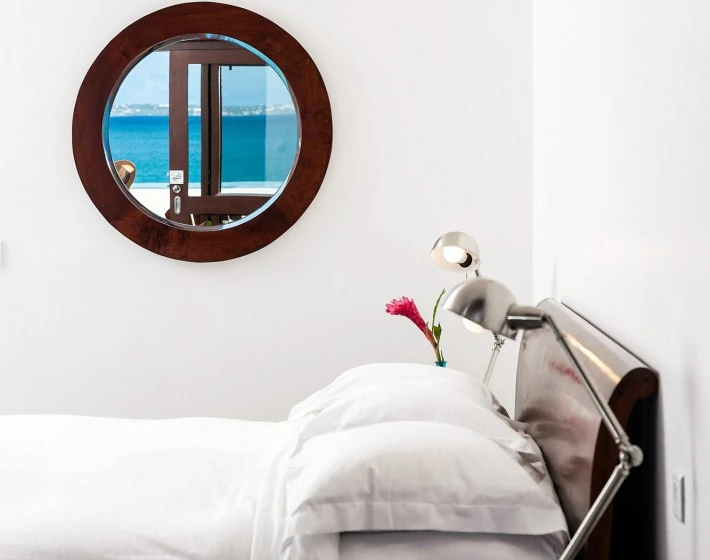 a mirror above a bed