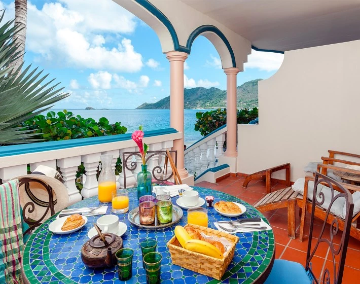 table on balcony with lots of food on the table