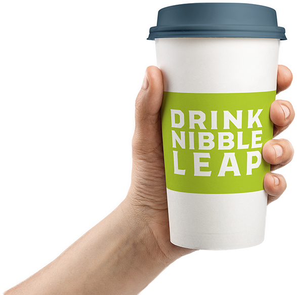 Hand holding to-go coffee cup