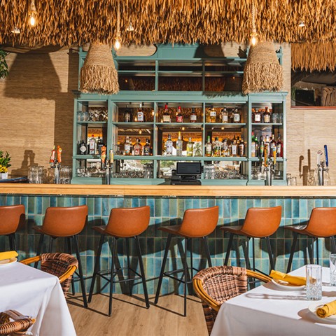 a bar with tables and chairs