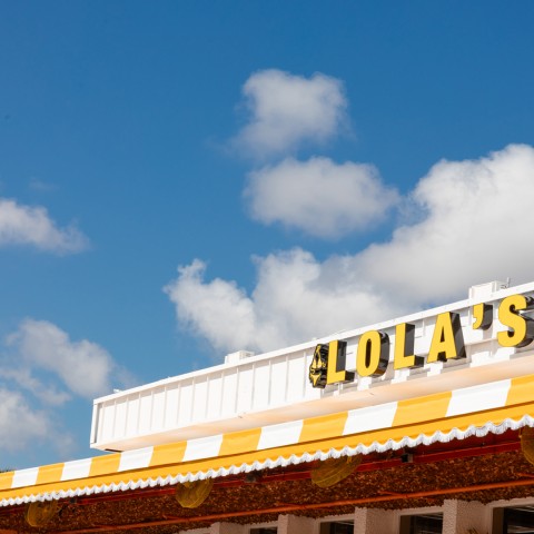 a yellow and white building with a sign on top