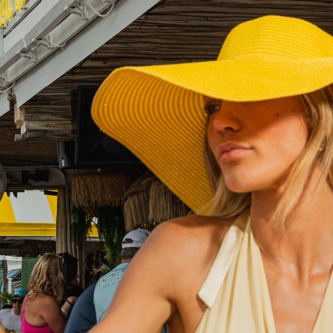 a woman wearing a yellow hat