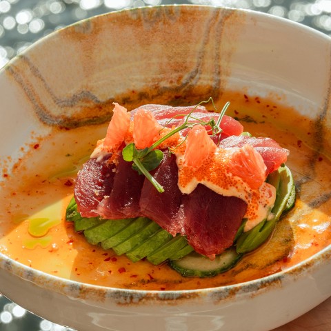 a bowl of food with fish and vegetables