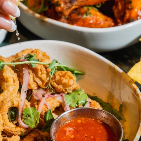 a bowl of fried food with sauce