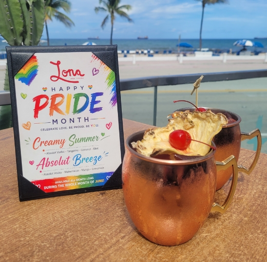 a sign next to a copper mug with a drink on a table