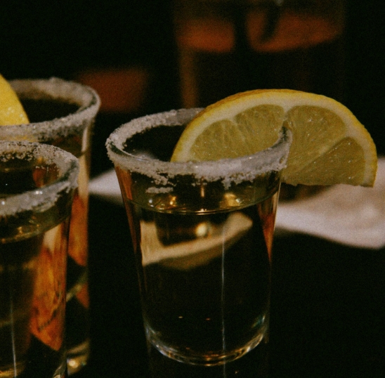 a group of shot glasses with a lemon wedge