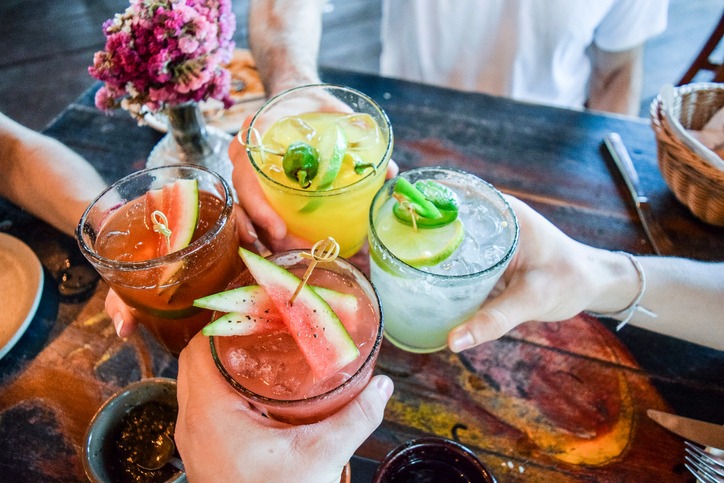 a group of hands holding drinks