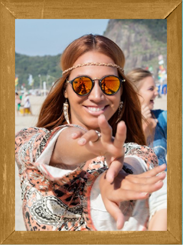 a woman wearing sunglasses and smiling at camera