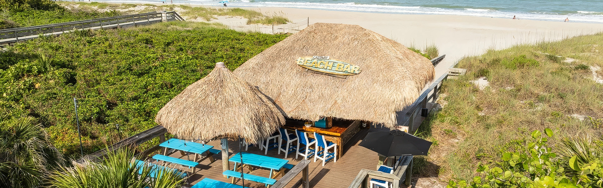 a thatched roof bar on a beach