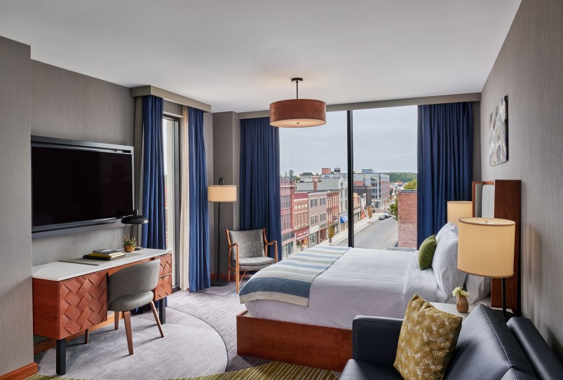 a room with a bed and a television
