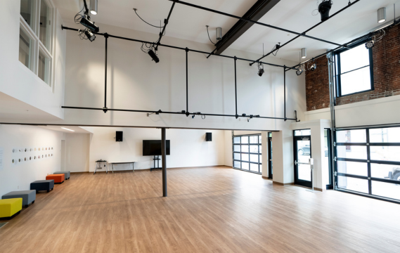 a large room with a wood floor and a wood floor