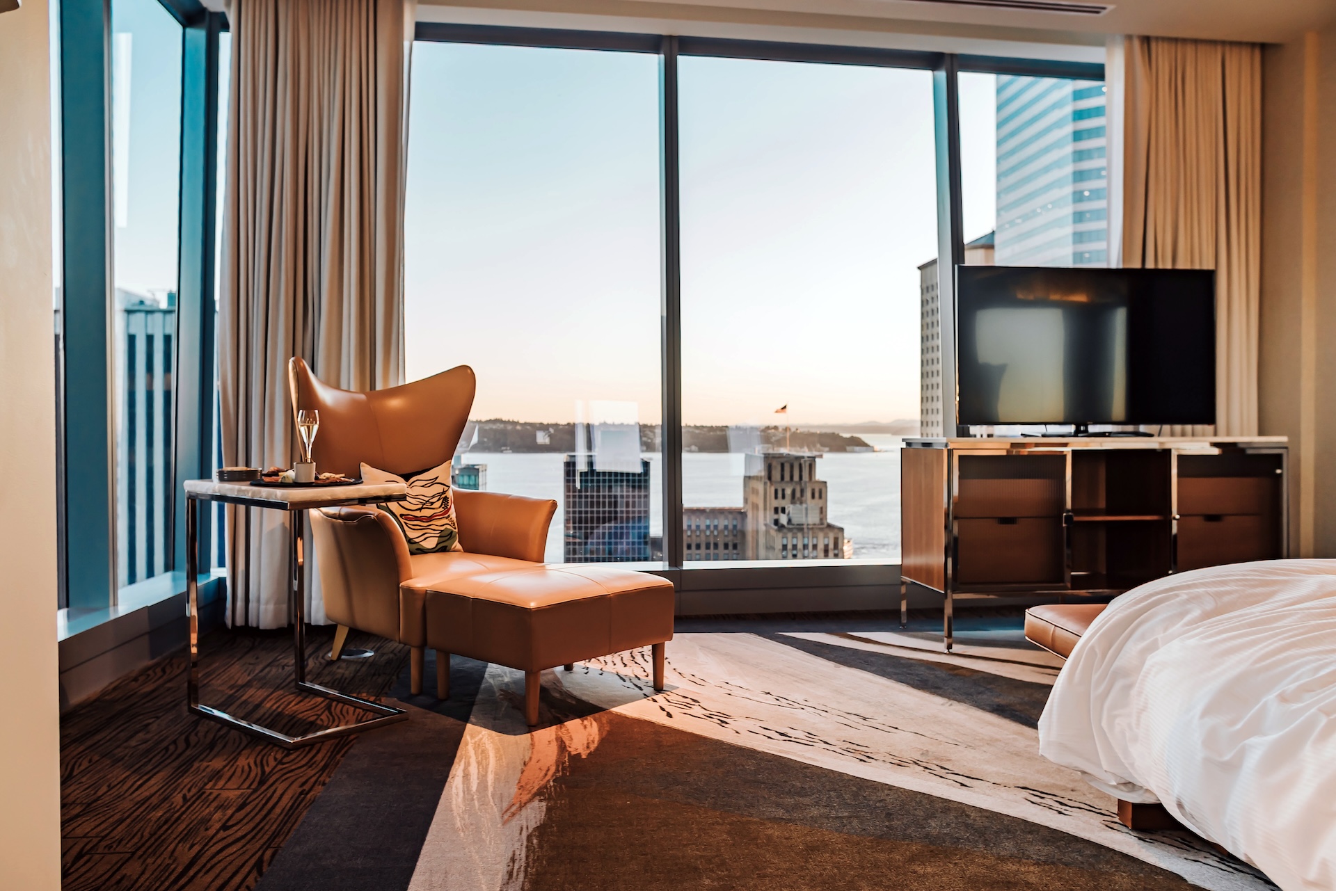 a room with a large window and a couch and a television