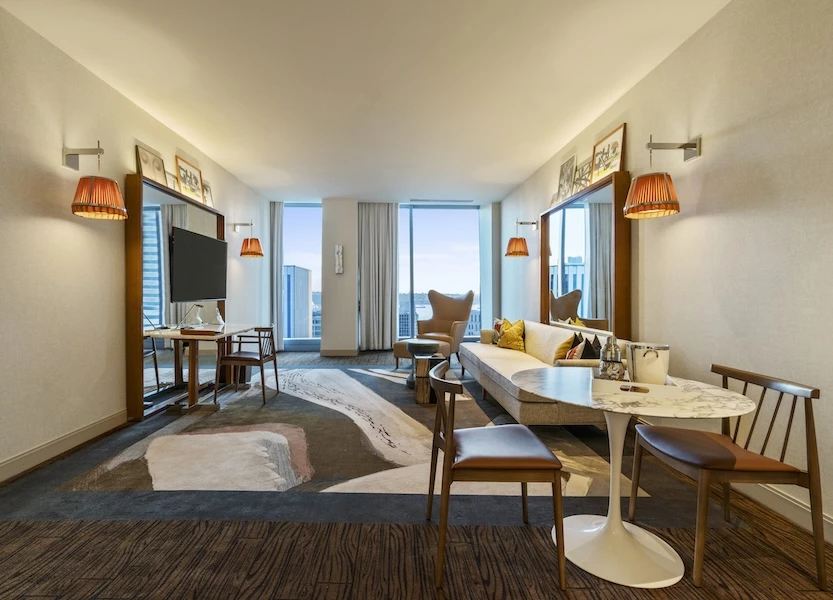 a room with a couch and chairs