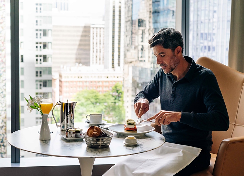 a man sitting at a table eating food