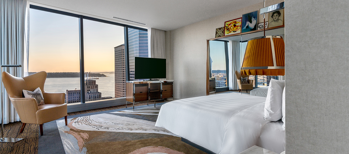 a room with a large window and a large bed