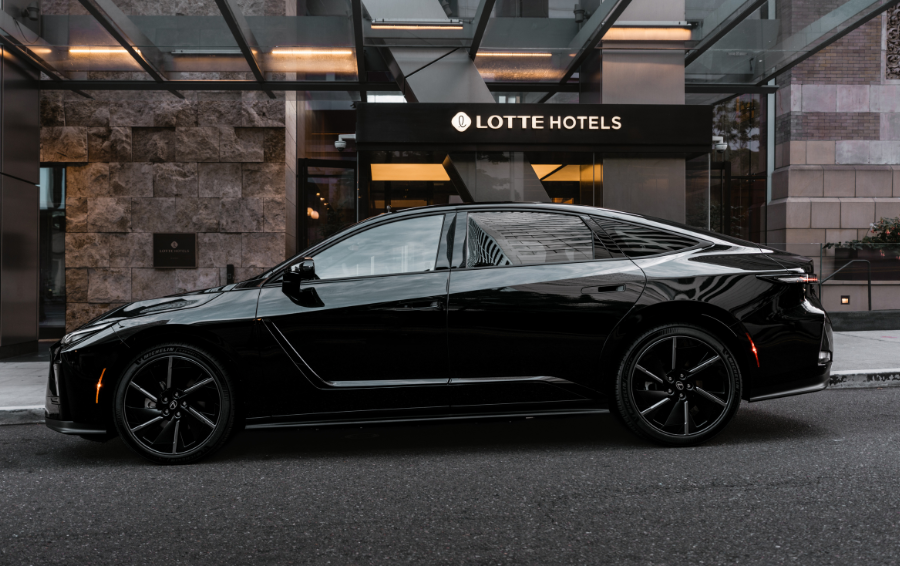a black car parked in front of a hotel