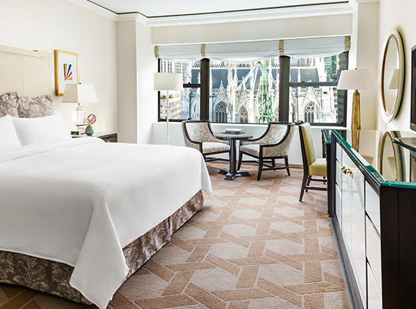 hotel room with large window facing a cathedral