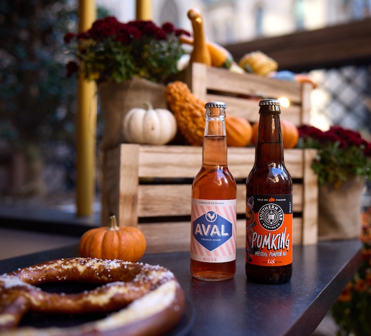 a beer bottles and a pretzel on a table