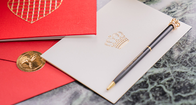 a pen and a notepad on a marble surface