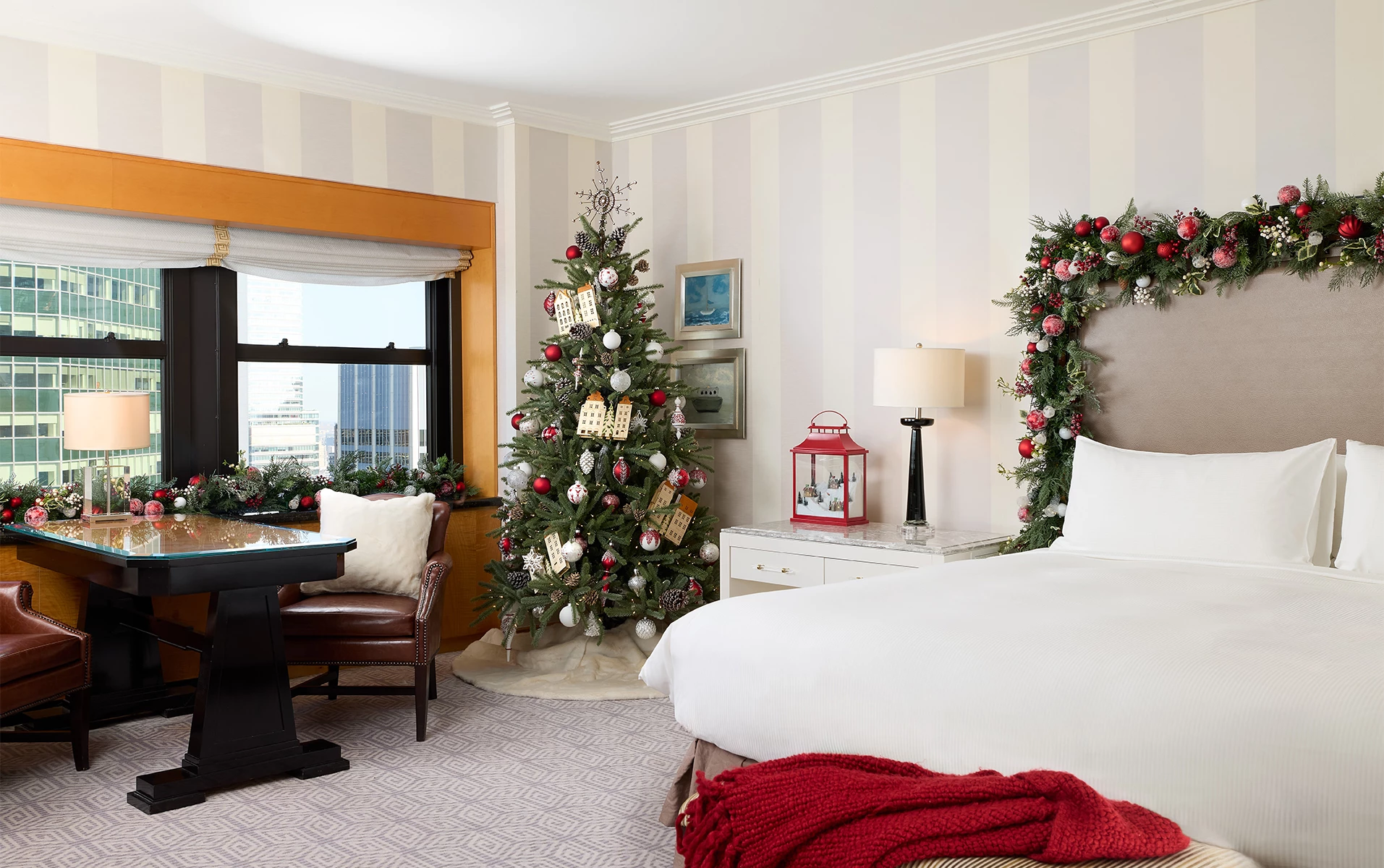 a bedroom with a christmas tree and a table