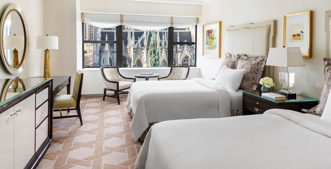 a room with two beds and a table