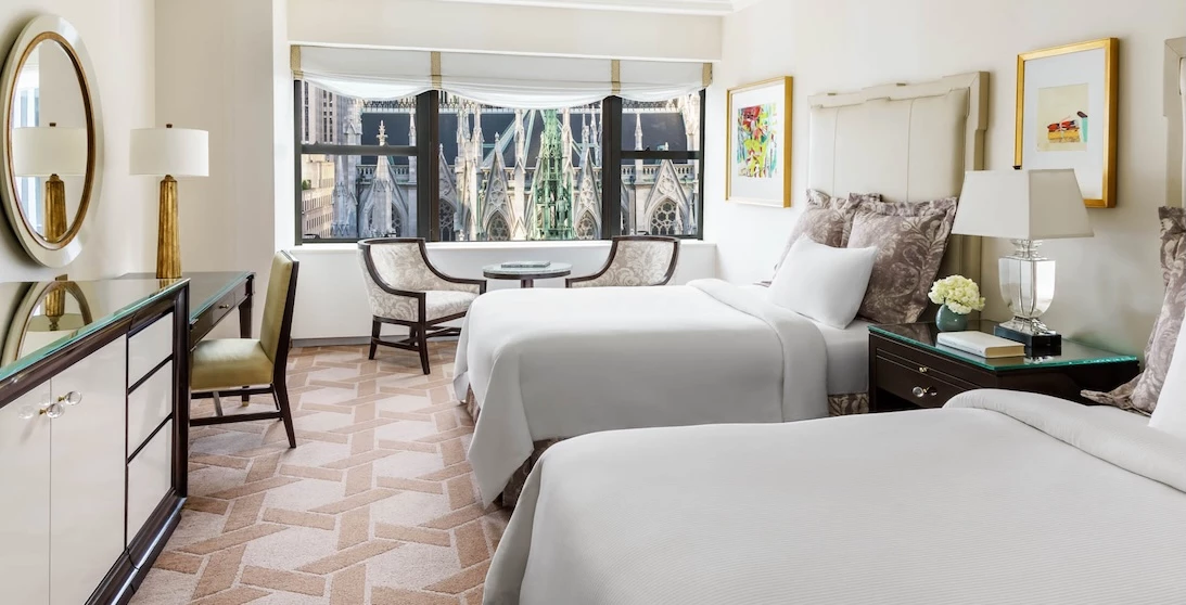 a room with two beds and a table