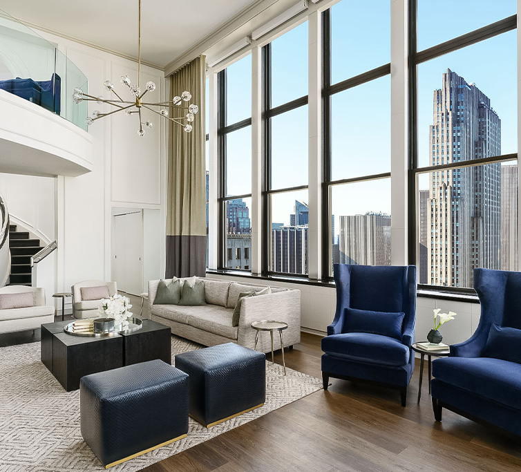 angled view of living room with floor to ceiling penthouse windows