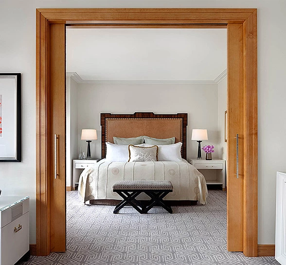 entrance to suite bedroom with light wooden fixtures