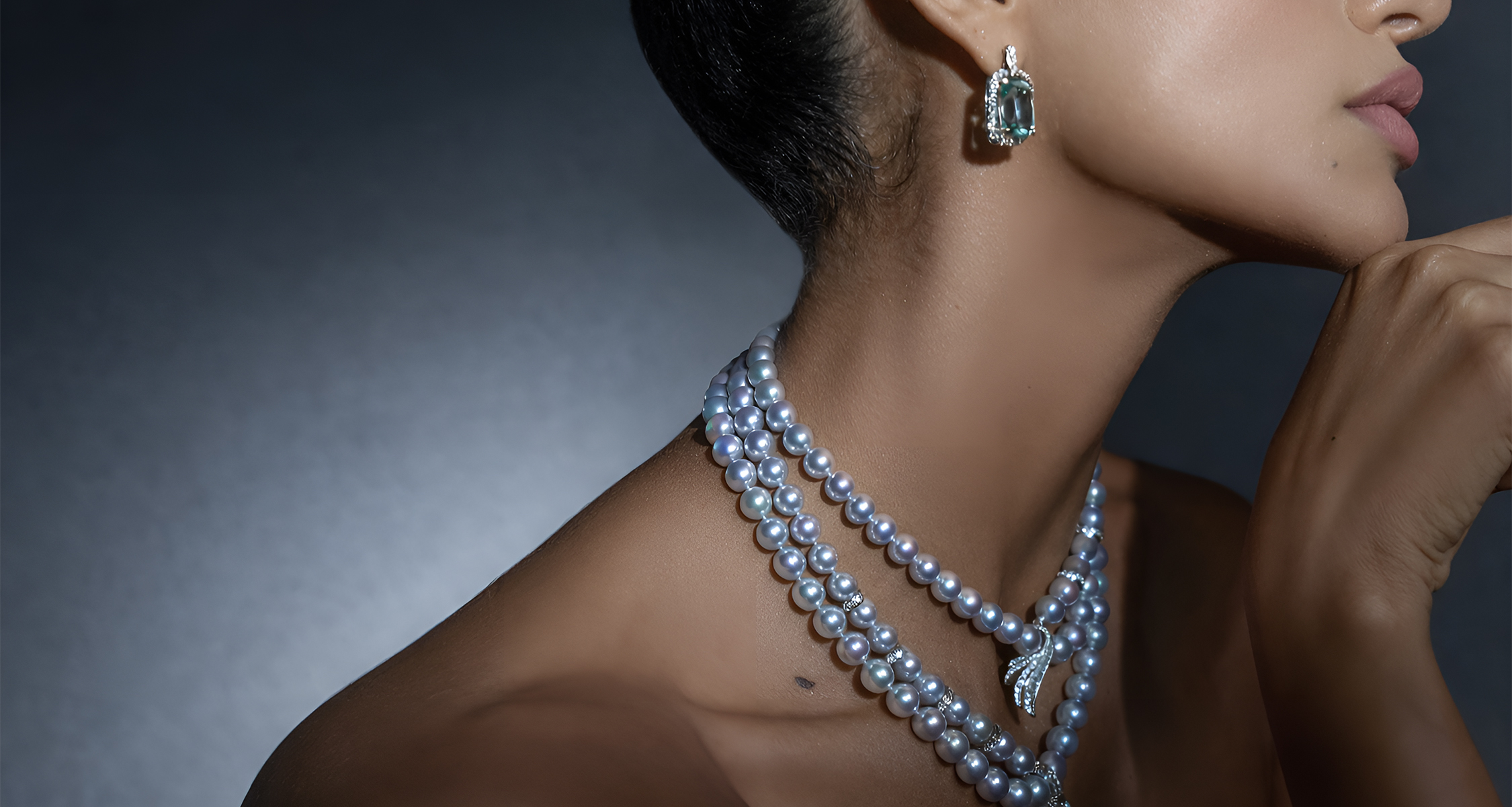 a woman wearing a necklace and earrings