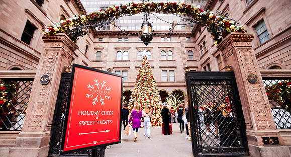 a large building with a large tree and a large sign