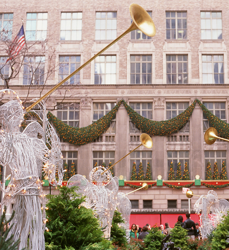 a group of statues with trumpets in front of a building