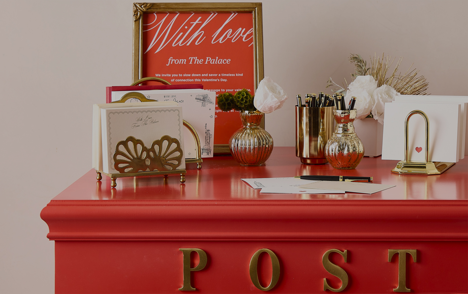 a red box with a picture frame and a vase of flowers and a picture frame