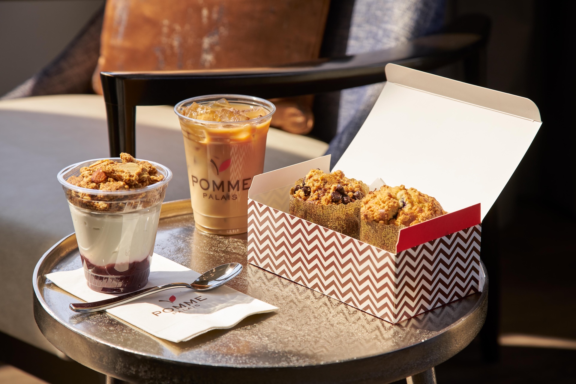 a cup of coffee and muffins on a table