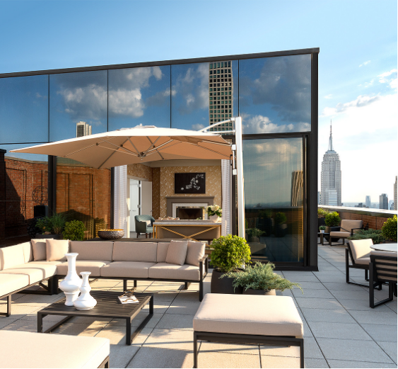 a patio with a large glass wall and a large building
