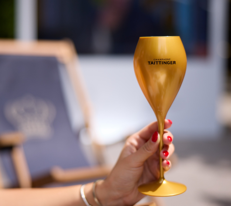a hand holding a gold wine glass