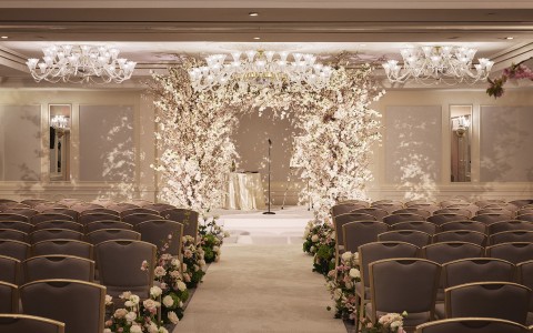 a wedding ceremony with chairs and flowers