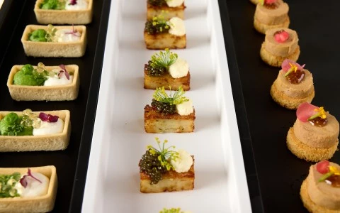 a rectangular white plate with small food on it