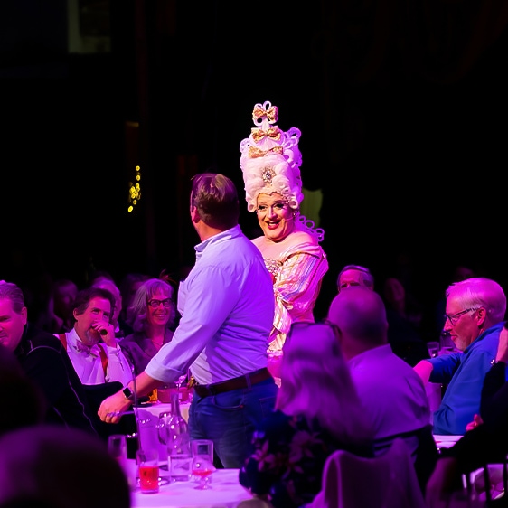 a man holding a woman's head in front of a crowd