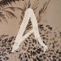 a white letter painted on a brown surface