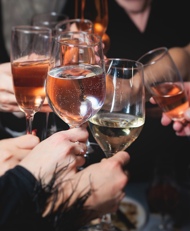 a group of people holding wine glasses