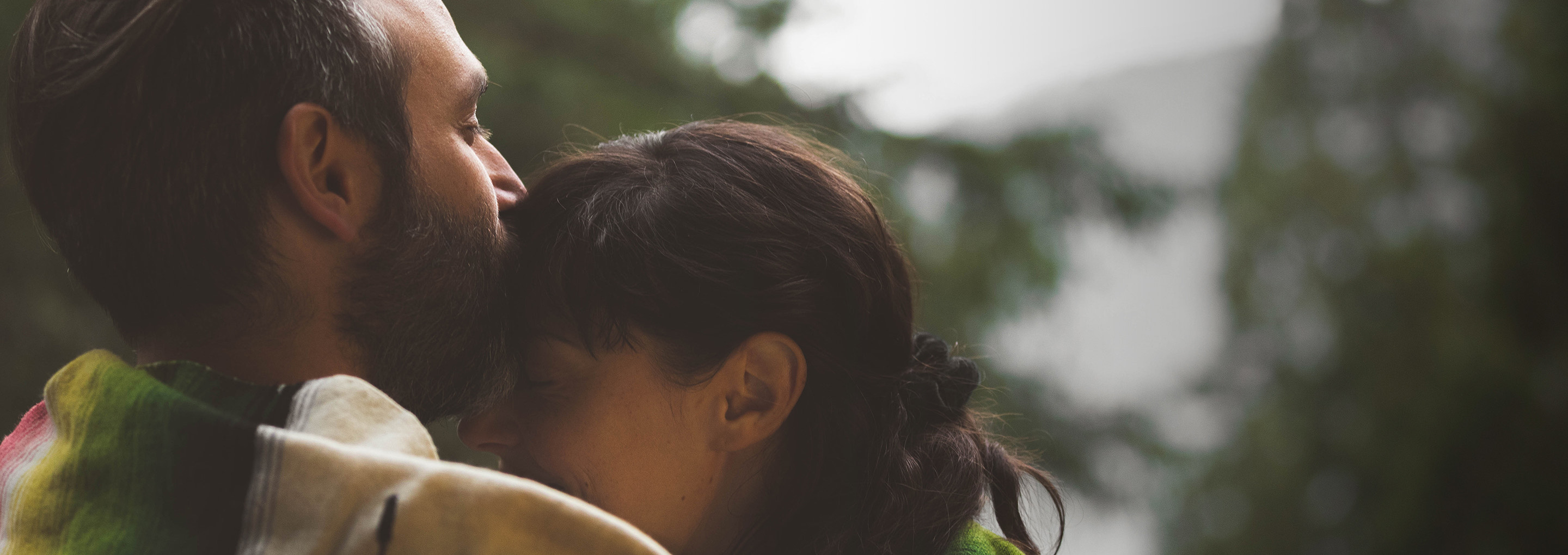 a man kissing a woman