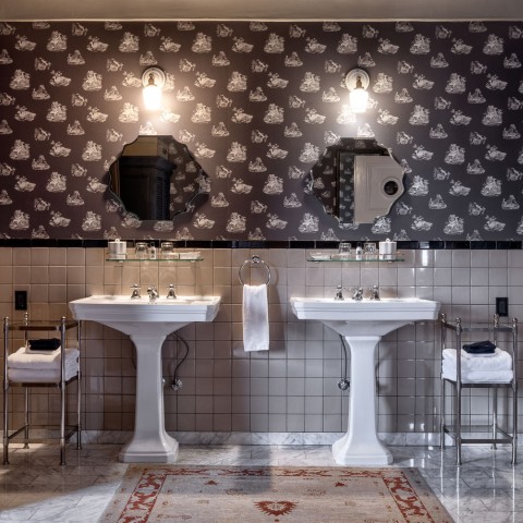 a bathroom with two sinks and mirrors