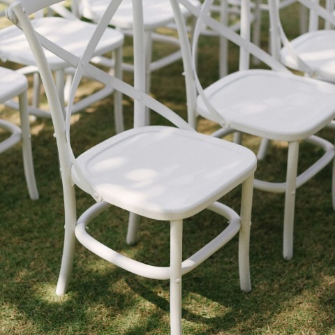 a group of white chairs on grass