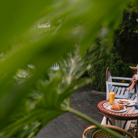 a woman sitting at a table with food on it