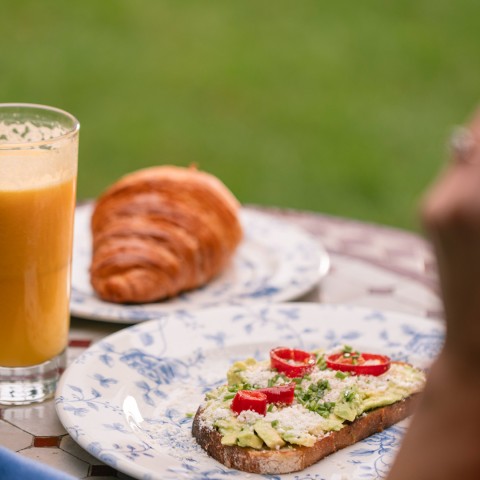 a plate of food and a glass of juice